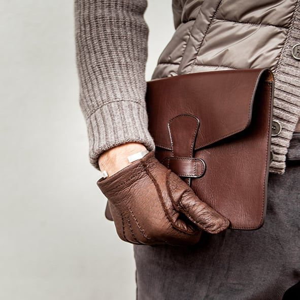 Guy holding a Frank Clegg Chocolate Ipad Case wearing Hestra Gloves