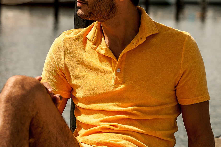 Gabriel hanging out by the bridge in a yellow toweling polo.