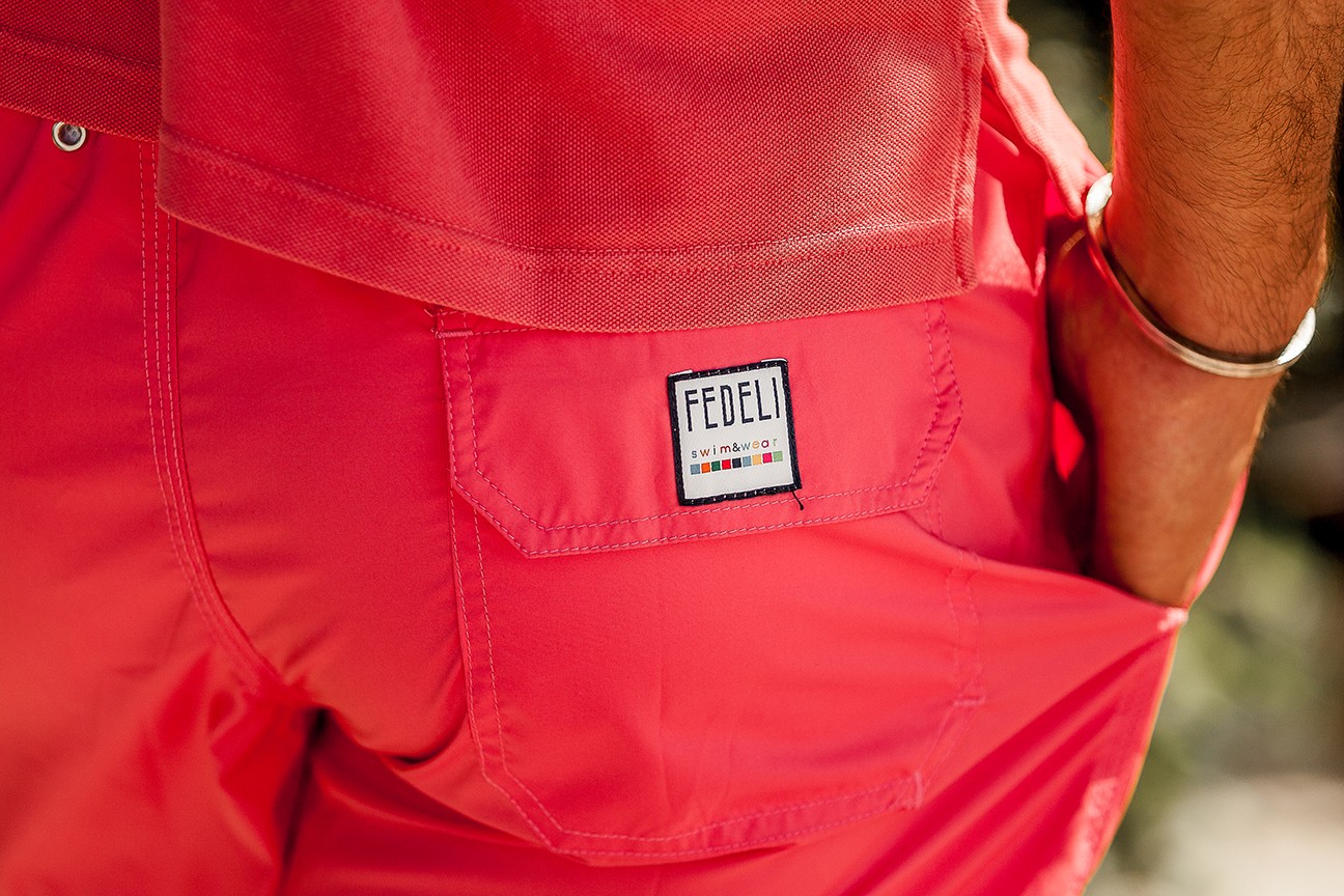 Close up on the coral madeira swim shorts together with the coral cotton pique polo